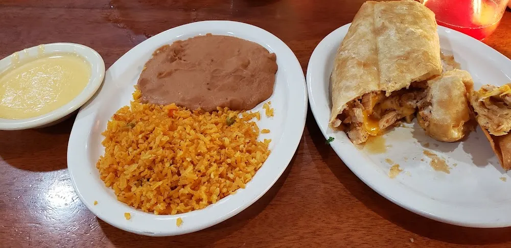 Chicken Chimichanga with Queso on the Side Side of Rice and Beans